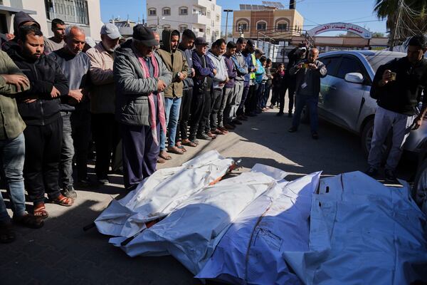 Mourners pray over the bodies of Palestinians killed in the Israeli bombardment of the Gaza Strip as they are brought for burial at Al-Aqsa Hospital in Deir al-Balah, Wednesday, March 19, 2025. (AP Photo/Abdel Kareem Hana)