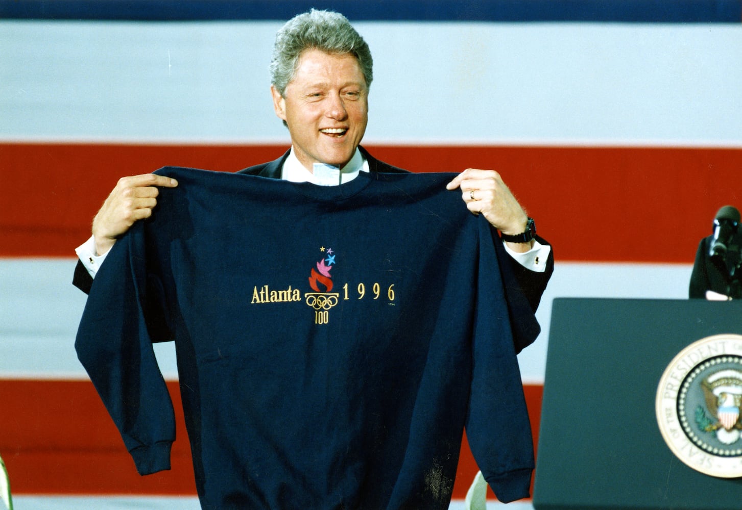 President Bill Clinton displays an Atlanta 1996 Olympic sweatshirt (size XXL) that Atlanta Mayor Bill Campbell presented to him at a Clinton rally at CNN Center in Atlanta Tuesday, May 3, 1994. 
MANDATORY CREDIT: DIANE LAAKSO / THE ATLANTA JOURNAL-CONSTITUTION