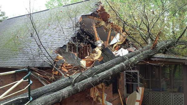 A tree fell into this house in the 1200 block of Tred Avon Way in unincorporated Lilburn on Wednesday. (Credit: Gwinnett fire)