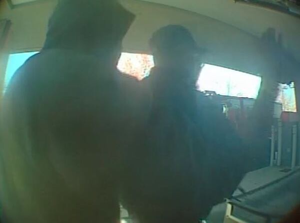 A surveillance photo of a man robbing an armored-car courier in DeKalb County.