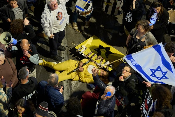 People take part in a protest demanding the immediate release of hostages held by Hamas in the Gaza Strip, in Tel Aviv, Israel, Saturday, March 22, 2025. (AP Photo/Ohad Zwigenberg)