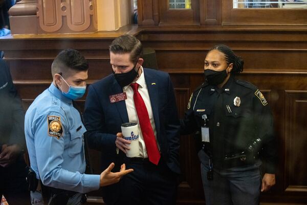 At the direction of Georgia House Speaker David Ralston, a state trooper escorts state Rep. David Clark out of the chamber after he refused to submit to testing for the coronavirus. The General Assembly began this year's session with a rule that requires all legislators and employees to undergo testing for the virus twice a week. MANDATORY CREDIT: NATHAN POSNER