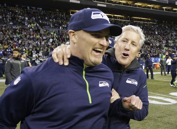 Seattle Seahawks head coach Pete Carroll, right, celebrates with defensive coordinator Dan Quinn, left, after they defeated the St. Louis Rams 20-6 in an NFL football game, Sunday, Dec. 28, 2014, in Seattle. (AP Photo/Scott Eklund)