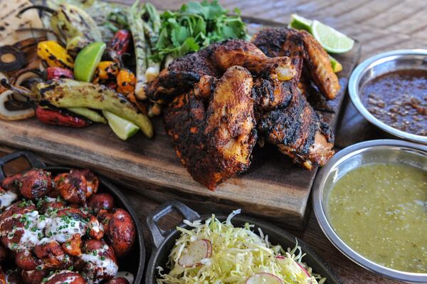 One of the menu highlights at Ladybird Grove & Mess Hall is the spatchcocked chicken. Grilled onions, chiles, cactus strips and a stack of hot tortillas come on the side with two salsas, a pan of roasted potatoes and a bowl of slaw. (Becky Stein / beckysteinphotography.com)