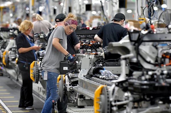 Manufacturing workers assemble electric vehicles at Rivian in Normal, Ill., on July 20, 2022. (Photo for The Atlanta Journal-Constitution by Ron Johnson)