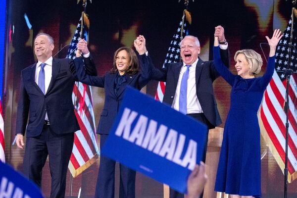 Vice President Kamala Harris (second from left) and her running mate, Minnesota Gov. Tim Walz (second from right) along with spouses Doug Emhoff and Gwen Walz, are cheered at the Democratic National Convention in Chicago.