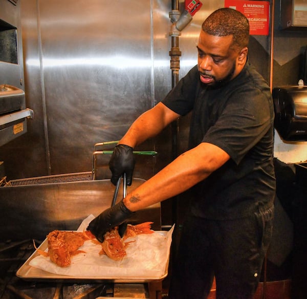 Executive chef Christian Lucke Bell removes fried snapper from the deep fryer at Rock Steady. CONTRIBUTED BY CHRIS HUNT PHOTOGRAPHY