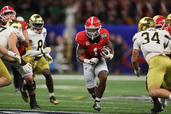 Georgia running back Trevor Etienne picking up yardage before fumbling at the Notre Dame 10 yard line at the Sugar Bowl at the Caesars Superdome Thursday, Jan. 2, 2025, in New Orleans. (Jason Getz / AJC)
