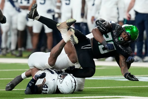 Oregon running back Jordan James (20) is tackled by Penn State linebacker Kobe King (41) during the first half of the Big Ten championship NCAA college football game, Saturday, Dec. 7, 2024, in Indianapolis. (AP Photo/Darron Cummings)