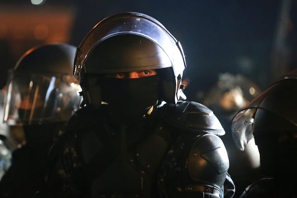 A police officer looks on during a rally outside the parliament's building to protest the government's decision to suspend negotiations on joining the European Union for four years in Tbilisi, Georgia, on Saturday, Nov. 30, 2024. (AP Photo/Zurab Tsertsvadze)