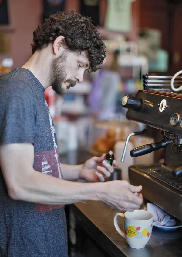 Jason Hoover, a barista, prepares a CBD oil latte at Rev Coffee in Smyrna, which offers a CBD oil latte as well as the option to add the compound to any beverage. Cannabidiol oil products are gaining in popularity. Bob Andres / bandres@ajc.com