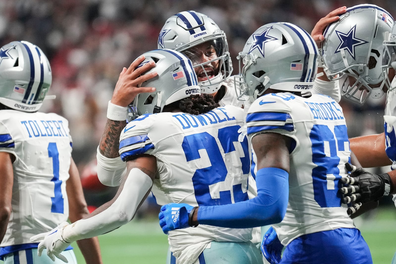 Dallas Cowboys running back Rico Dowdle (23) celebrates a touchdown reception with quarterback Dak Prescott and wide receiver Jalen Brooks during the first half of an NFL football game against Atlanta Falcons, Sunday, Nov. 3, 2024, in Atlanta. (AP Photo/ Brynn Anderson)