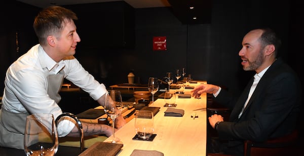 Jeff Lewis (right) chats with J. Trent Harris, executive chef at Mujo. Lewis and his wife Amy dine regularly at the restaurant. Chris Hunt for The Atlanta Journal-Constitution 