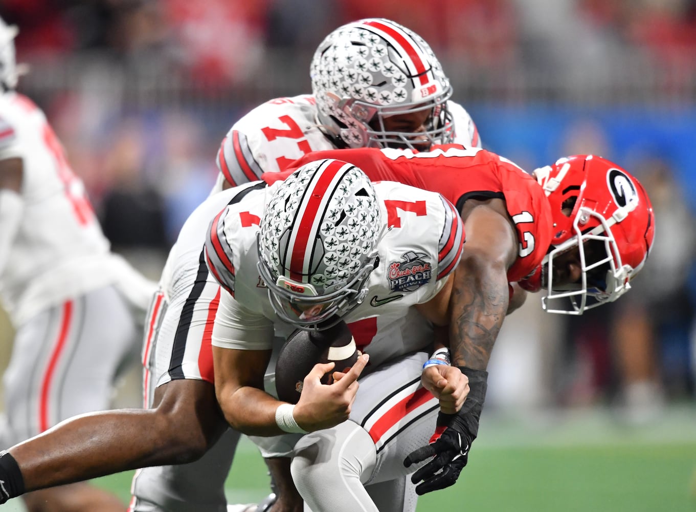 Ohio State Buckeyes quarterback C.J. Stroud (7) is sacked for a 9-yard loss by Georgia Bulldogs defensive lineman Mykel Williams (13) during the second quarter. (Hyosub Shin / Hyosub.Shin@ajc.com)