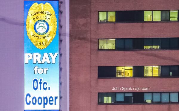 A sign supporting wounded Covington police Officer Matt Cooper is displayed outside Grady Memorial Hospital, within view of Cooper's hospital room. JOHN SPINK / JSPINK@AJC.COM