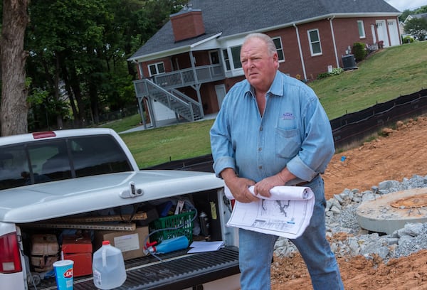 Stoney Birt works in Sugar Hill to prepare for a new subdivision on Friday, May 13, 2022.  Stoney has written a book about his father, Billy Sunday Birt, a convicted killer who repented in prison before his passing.  Stoney and his brother are writing competing books about the family patriarch.  (Jenni Girtman for The Atlanta Journal-Constitution)