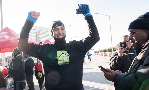 Brian Sydow reacts while being interviewed after winning the raffle for tickets to the big game during the Extra Yard 5K., the offiical race of the College Football Playoff National Championship, on Sunday Jan. 7, 2018, in Atlanta. As the raffle winner, he also won one of the three sets of tickets awarded to Monday’s college football national championship game at Mercedes-Benz Stadium.