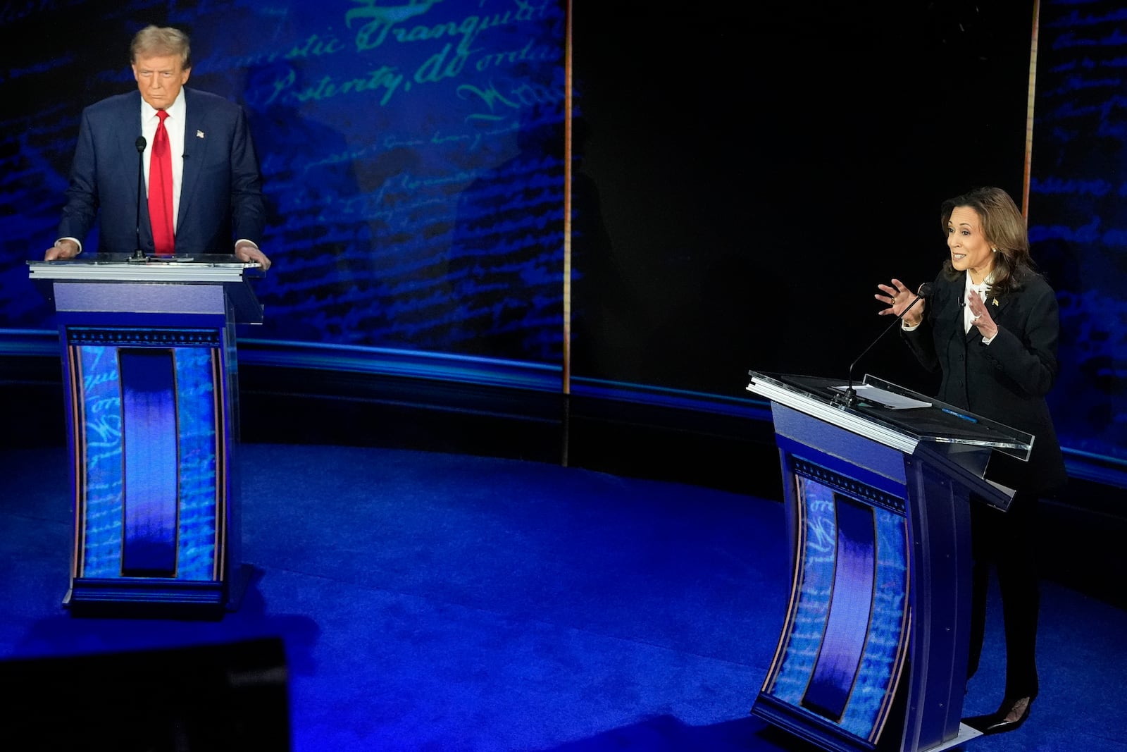 FILE - Republican presidential nominee former President Donald Trump watches as Democratic presidential nominee Vice President Kamala Harris speaks during an ABC News presidential debate, Sept. 10, 2024, in Philadelphia. (AP Photo/Alex Brandon, File)