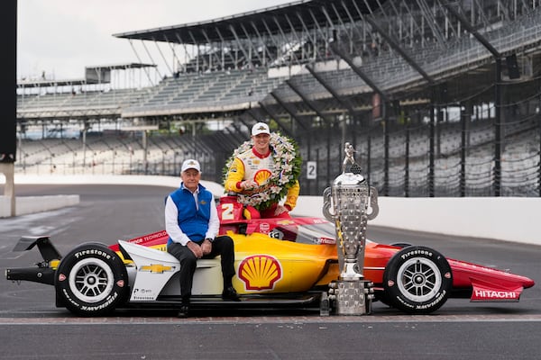 FILE - Roger Penske and Josef Newgarden pose with the Borg-Warner Trophy during the traditional winner's photo session at Indianapolis Motor Speedway, Monday, May 27, 2024, in Indianapolis, the day after he won the 108th running of the Indianapolis 500 auto race. (AP Photo/Darron Cummings, File)