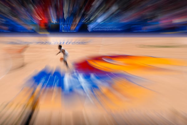 In this photo taken with a slow shutter speed, Kansas guard David Coit drives during the second half of an NCAA college basketball game against Oklahoma State, Saturday, Feb. 22, 2025, in Lawrence, Kan. Kansas won 96-64. (AP Photo/Charlie Riedel)