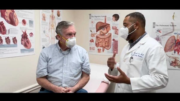 Dr. Cecil Bennett, right, a primary care physician in Newnan, believes federal public health officials should allow people to get the Johnson & Johnson vaccine, with warnings about potential side effects for women between the ages of 20 and 55. (Mildred Vaughn)