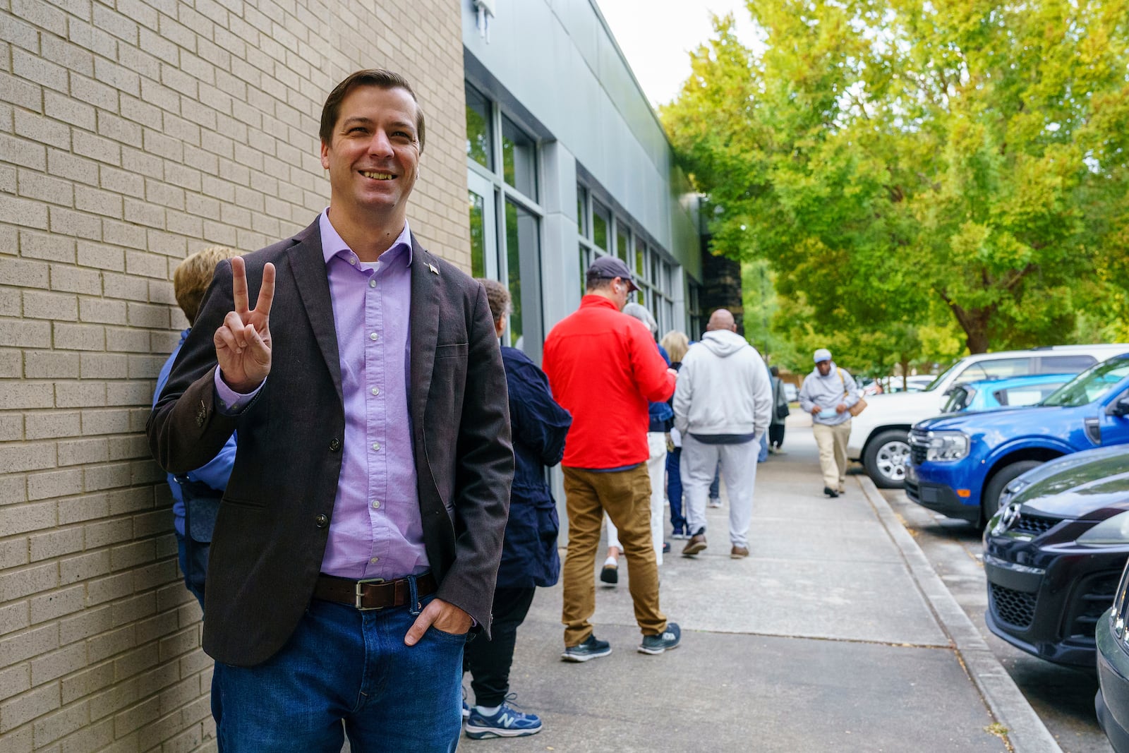 Libertarian presidential candidate Chase Oliver stands in line to vote in Tucker, Ga., on Tuesday.