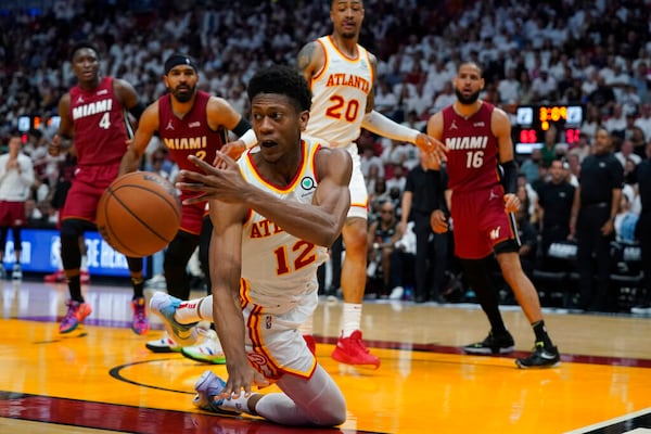 Atlanta Hawks forward De'Andre Hunter (12) tries to control the ball  during the second half of Game 5 of an NBA basketball first-round playoff series against the Miami Heat, Tuesday, April 26, 2022, in Miami. (AP Photo/Wilfredo Lee)