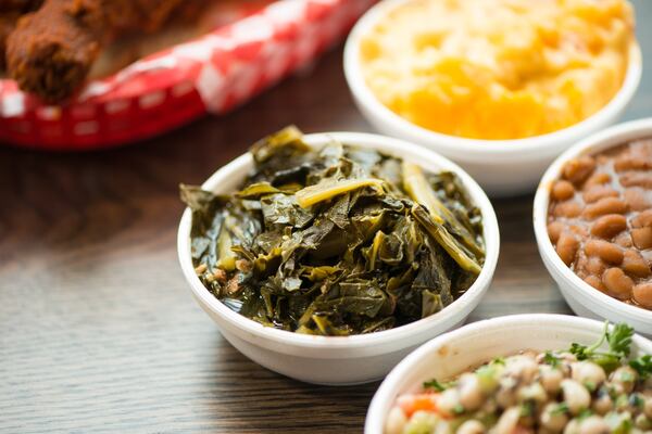 One of the better Hattie B’s sides is Southern greens (left). Also pictured are pimento mac and cheese, baked beans and black-eyed pea salad. CONTRIBUTED BY MIA YAKEL