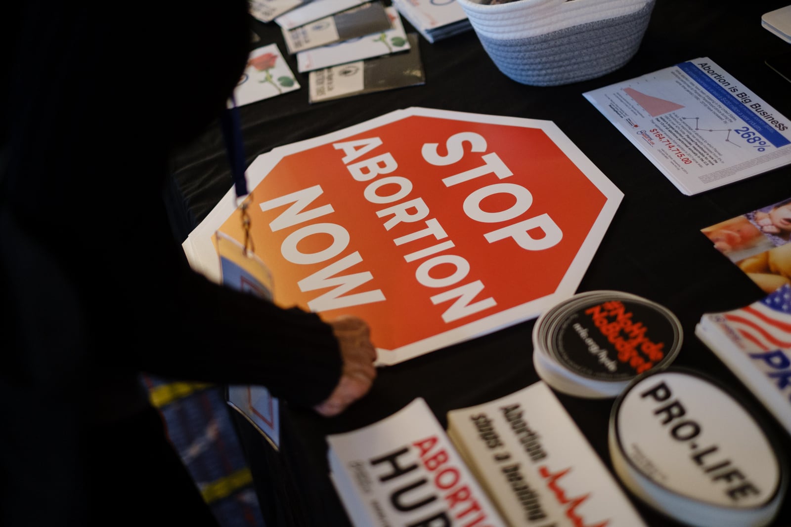 A person looks at materials at the National Right to Life booth at the National Right to Life Convention at the Airport Marriott Hotel in Atlanta on Friday, June 24, 2022. (Arvin Temkar / arvin.temkar@ajc.com)