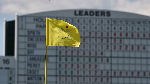 Wind whips the flag on the 17th green during the 2016 Masters Golf Tournament at the Augusta National Golf Club.