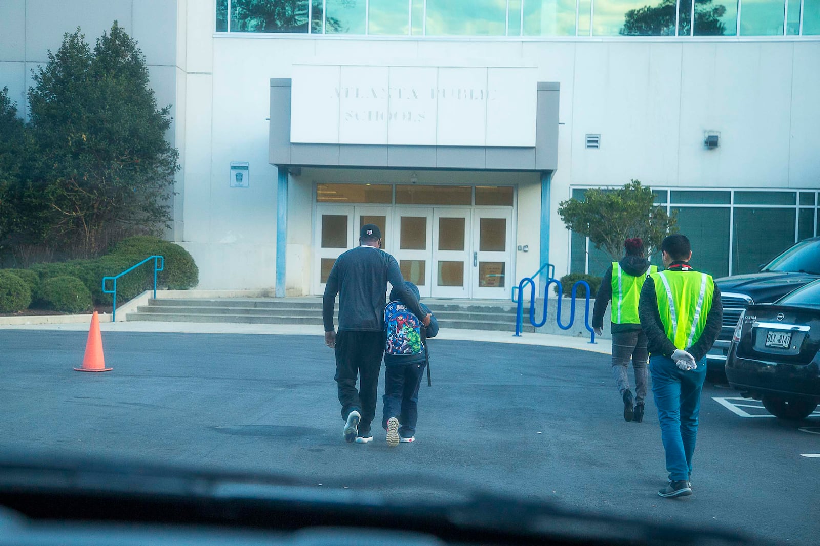 Harper-Archer Elementary School staff walk Corbin into the school after retrieving him from his grandmother, Wednesday, February 26, 2020.  (ALYSSA POINTER/ALYSSA.POINTER@AJC.COM)