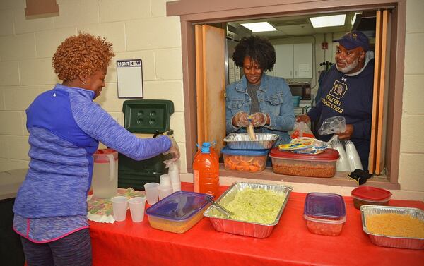 Volunteers from Mount Zion AME Church — (from left) Lonetta Johnson and wife and husband Rosalind and Emmett Watkins — help prepare a taco night dinner at Hagar’s House in Decatur recently. Hagar’s House, part of Decatur Cooperative Ministry, is an emergency shelter providing up to 90 days of shelter and support for families with children. CHRIS HUNT / SPECIAL