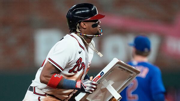 Ronald Acuna Jr. holds the bag after stealing second base in the 10th inning of a baseball game against the Chicago Cubs, Wednesday, Sept. 27, 2023, in Atlanta. The stolen base was Acuna's 70th of the season. (AP Photo/John Bazemore)