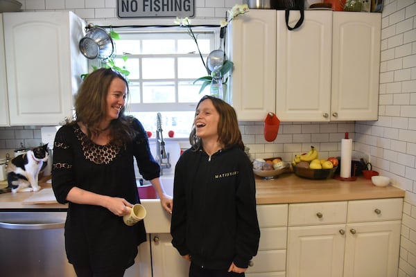 Children’s author Laurel Snyder shares a laugh with her son Mose, 11, at their home in Ormewood Park recently. HYOSUB SHIN / HSHIN@AJC.COM