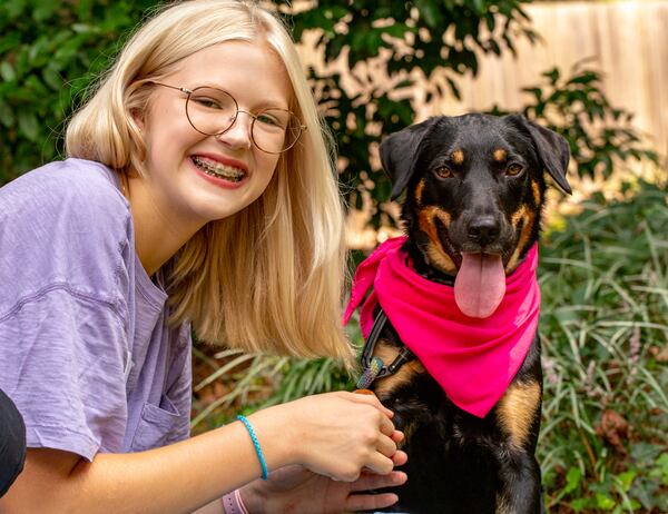 Jordan Ricks, 14, and her pandemic rescue dog DayZe are ready for school Tuesday, July 27, 2021.  Ricks, her friends and family were pleasantly surprised to see that Druid Hills High School's freshman orientation requested students to list their preferred pronouns on their name tags.  Jordan and her friends begin their freshman year, in person, at the DeKalb high school next week.  (Jenni Girtman for The Atlanta Journal-Constitution)