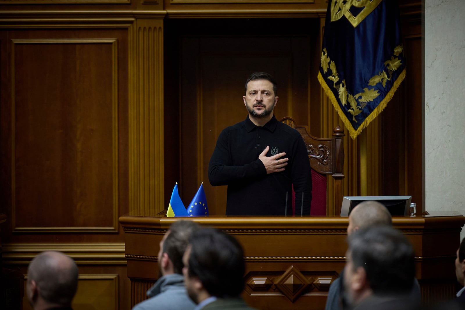 In this photo provided by the Press Service Of The President Of Ukraine on Oct. 16, 2024, Ukraine's President Volodymyr Zelenskyy listens to the national anthem before his speech at Verkhovna Rada in Kyiv, Ukraine. (Press Service Of The President Of Ukraine via AP)