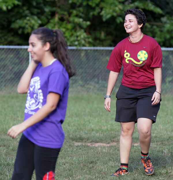 Luma Mufleh (right) laughs with mothers of her soccer players during their game in Clarkston on Sept. 12, 2012. She started a regular game with the mothers to teach them about the game their children love to play. Mufleh, Jordanian-born and now a U.S. citizen, is known for tough love, helping some of our newest and most vulnerable residents thrive. AJC FILE PHOTO