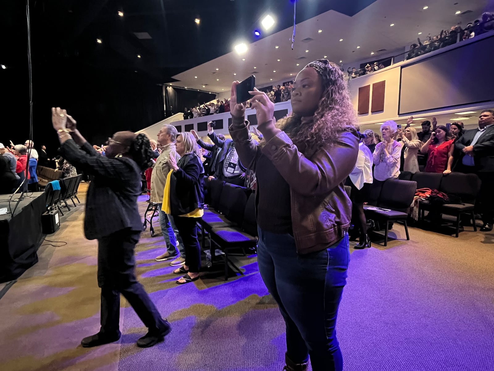 Bertha Brown (left) of McDonough and April Vaughn of Kennesaw snap photos during the inaugural National Faith Summit in Powder Springs on Oct. 28, 2024.