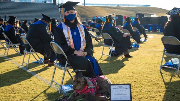 University of West Georgia student Maggie Leptrone with her dog, Mona, during the Dec. 5, 2020 commencement ceremony where she received a nursing degree. Mona, who came to all of Leptrone's classes because of the student's Type 1 Diabetes, received a "dog-ree" from the university. PHOTO CREDIT: UNIVERSITY OF WEST GEORGIA.