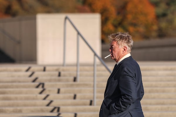 James Jacobson smokes outside of the federal courthouse after his arraignment on sex trafficking and interstate prostitution charges connected to the former CEO of Abercrombie & Fitch, Friday, Oct. 25, 2024, in Central Islip, N.Y. (AP Photo/Heather Khalifa)