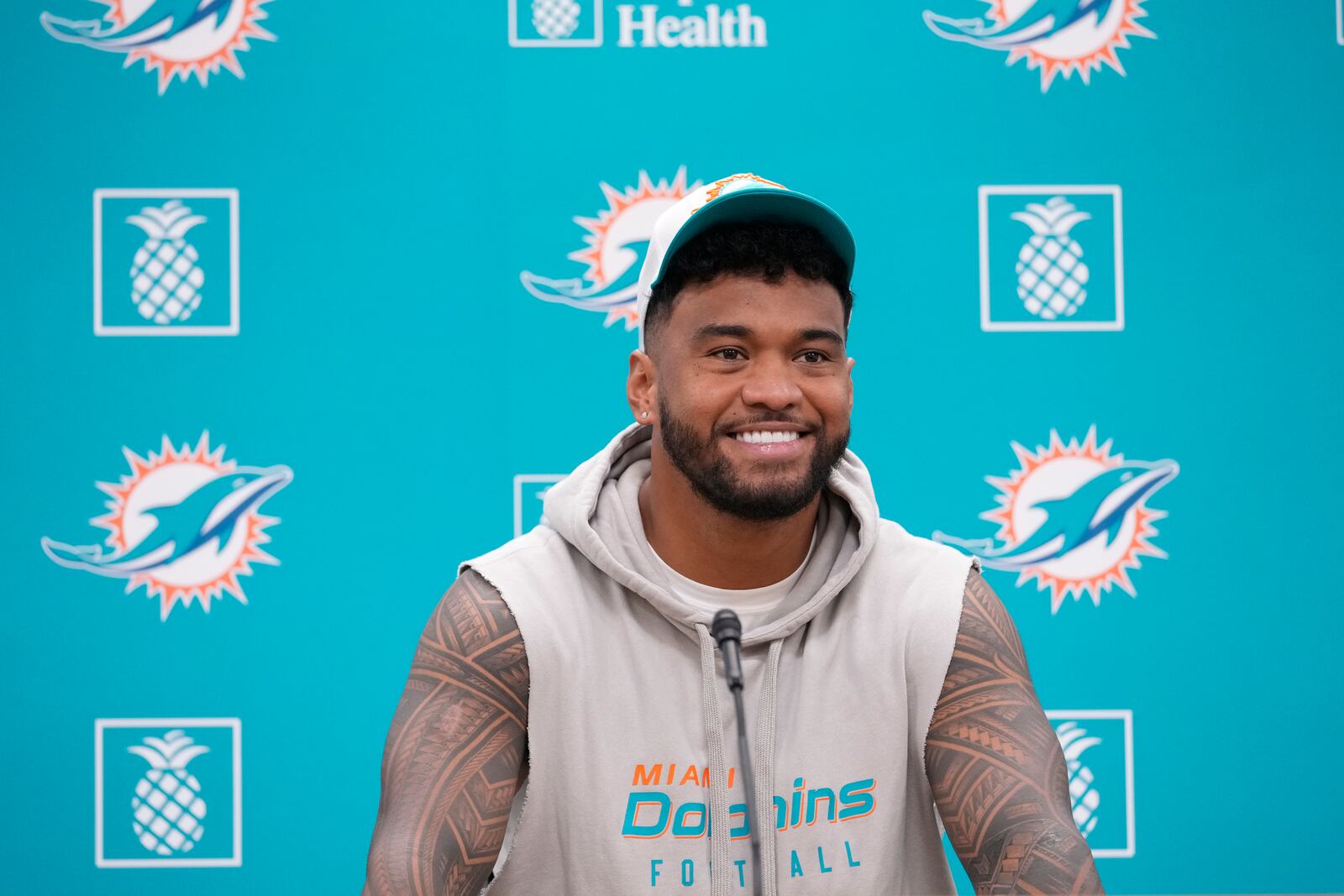 Miami Dolphins quarterback Tua Tagovailoa smiles as he takes questions during a news conference, Monday, Oct. 21, 2024, at the Dolphins training facility in Miami Gardens, Fla. (AP Photo/Wilfredo Lee)