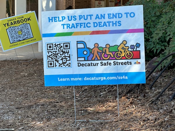 A sign promotes pedestrian and cyclist safety outside Beacon Hill Middle School in Decatur, Ga., on Tuesday, Feb. 25, 2025. (AP Photo/Jeff Amy)