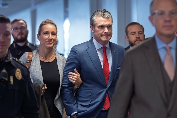 FILE - Pete Hegseth, President-elect Donald Trump's nominee to be defense secretary, right, joined by his wife Jennifer Rauchet, arrives at the Capitol in Washington, Dec. 5, 2024. (AP Photo/J. Scott Applewhite, File)