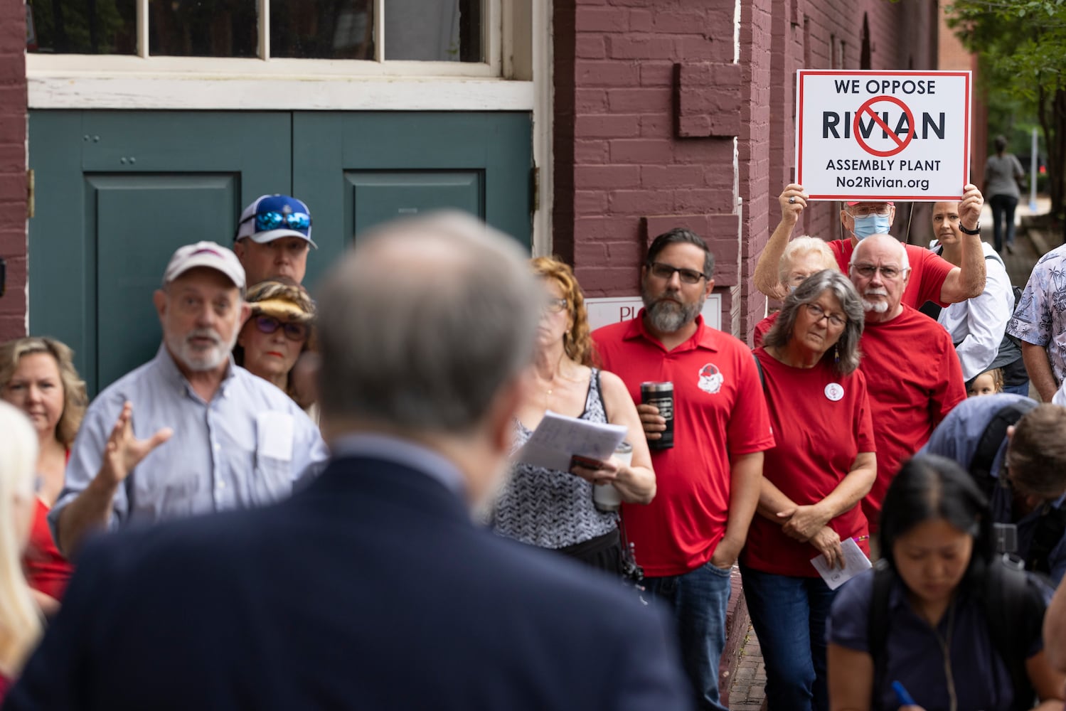 Citizens opposed to the measure gather outside to talk with their attorney, John Christy, after the Morgan County board of assessors voted to approve the Rivian tax exemption proposal in Madison on Wednesday, May 25, 2022.   (Bob Andres / robert.andres@ajc.com)