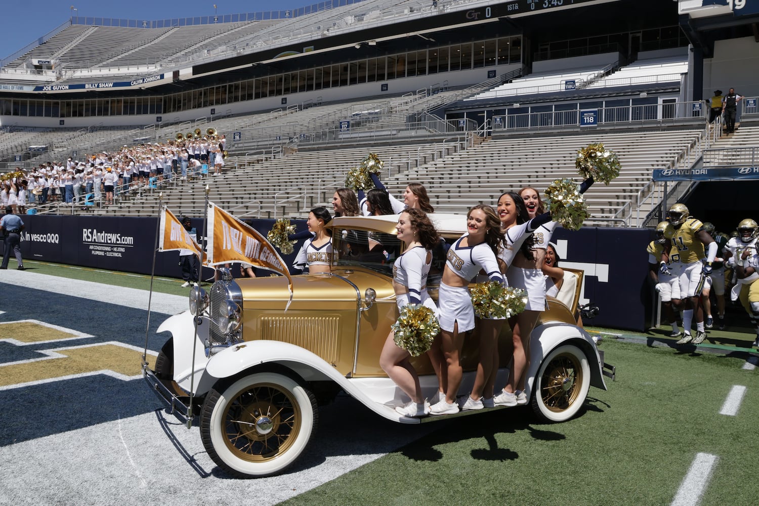 Cheerleaders ride the  Ramblin' Wreck onto the field during the Spring White and Gold game at Bobby Dodd Stadium at Hyundai Field In Atlanta on Saturday, April 13, 2024.   (Bob Andres for the Atlanta Journal Constitution)