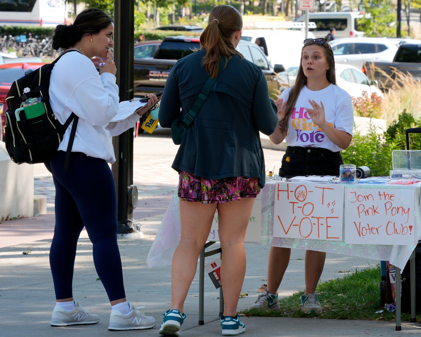 Marisa Myers, right, talks about registering to vote with University of Pittsburgh students on campus in Pittsburgh, Thursday, Sept. 12, 2024. (AP Photo/Gene J. Puskar)