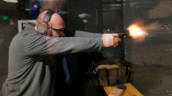 Jan. 5, 2016 -  Roswell - Nate Kern, senior instructor at the store, practices at the indoor range.  Patrons shop for guns and use the shooting range at Sharpshooters USA in Roswell.   The store sells firearms, and has an  indoor shooting range & training center.  BOB ANDRES  / BANDRES@AJC.COM