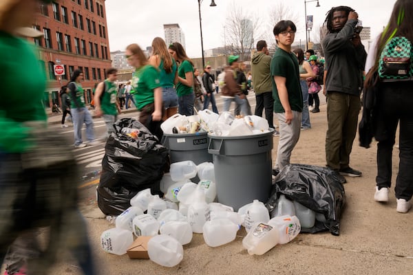 Empty containers used for homemade drinks overflow the garbage cans after the St. Patrick's Day parade, Sunday, March 16, 2025, in Boston, Mass. (AP Photo/Robert F. Bukaty)