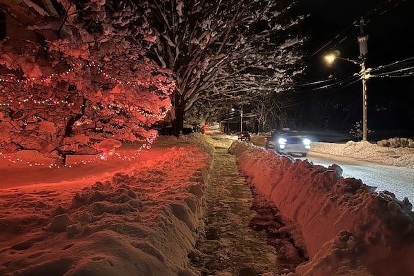 Drivers take advantage of the lull between lake-effect snowfalls in Lowville, N.Y., on Saturday, Nov. 30, 2024. (AP Photo/Cara Anna)