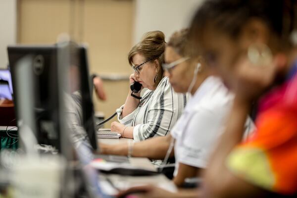 Clinical Consultant Cathy Tullos takes a call in the emergency command center at PruittHealth on Friday. The company set up the center to communicate with families during the coronavirus crisis and help them set up video chats with relatives in senior care facilities. BRANDEN CAMP/SPECIAL